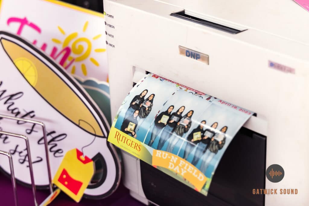 A printer producing a photo booth picture with a joyful snapshot emerging.