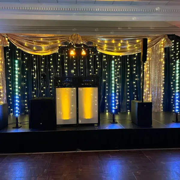 DJ setup with lights and gold curtain