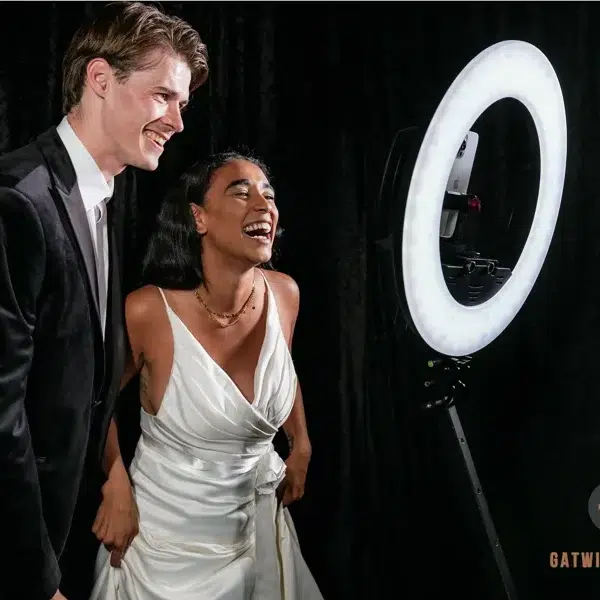 Bride and groom enjoying 360 photo booth experience