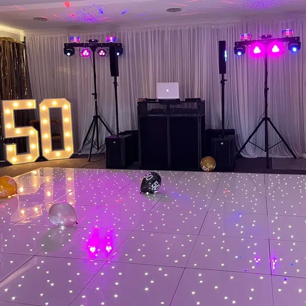 Starlit white LED dancefloor and DJ setup with “50” marquee lights in Crawley