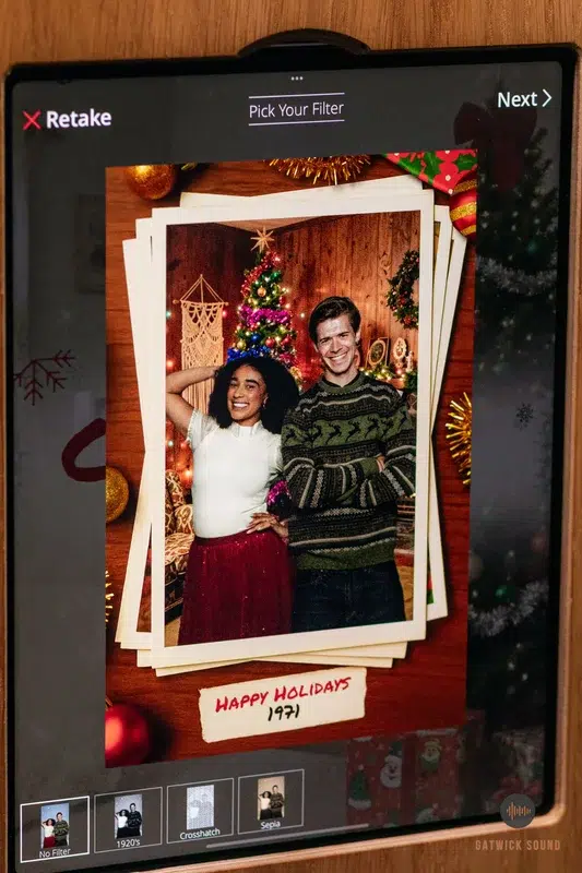 Christmas office party photo booth with festive backdrop and holiday props