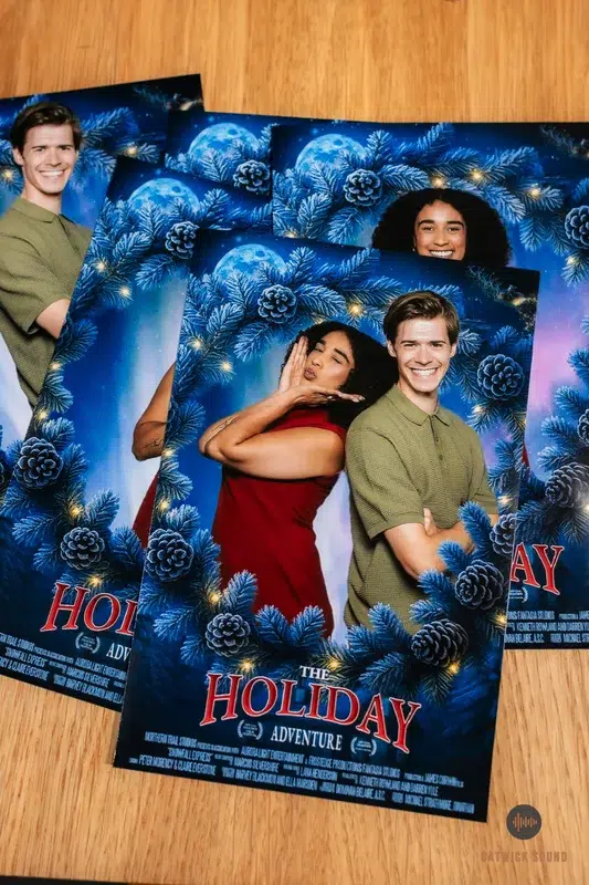 Printed Christmas photo booth postcards with festive blue pinecone design from Gatwick Sound