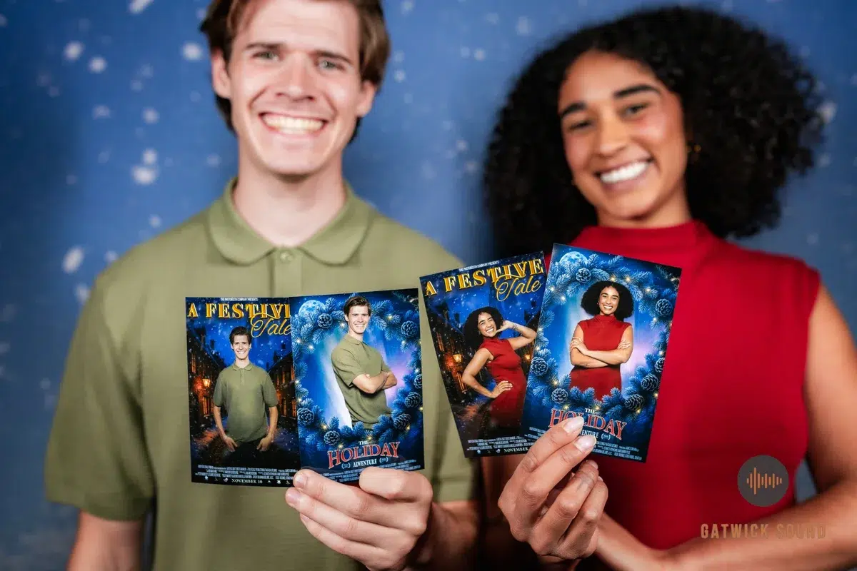 Guests holding festive Christmas photo booth prints with custom holiday design